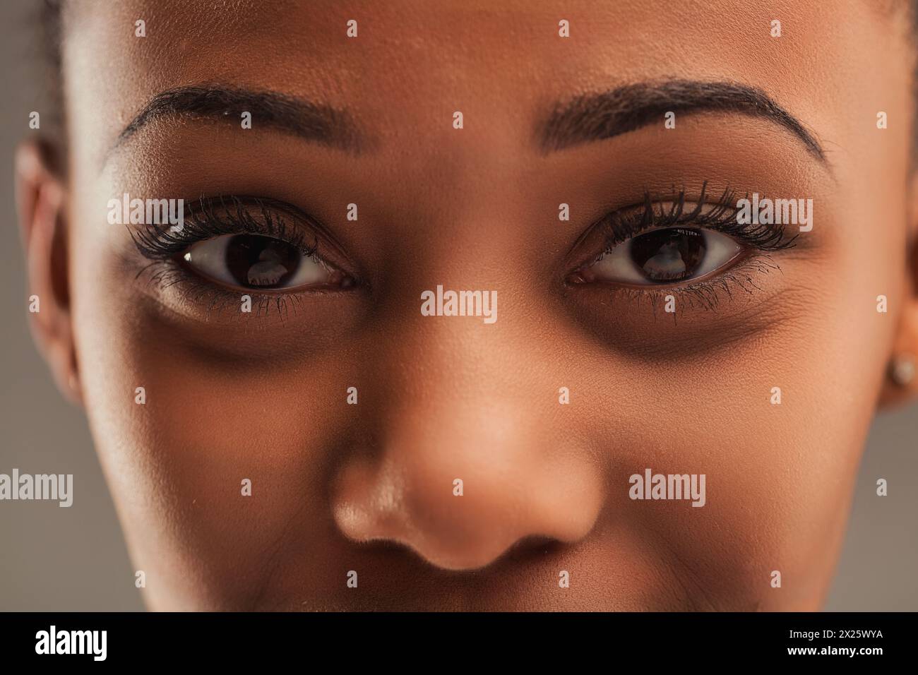Intense close-up of a woman's eyes, detailed with perfectly applied makeup, showcasing depth and emotion Stock Photo