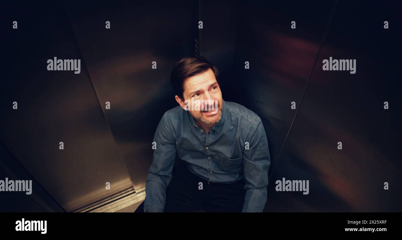 Man Suffering From Claustrophobia Trapped Inside Elevator Stock Photo