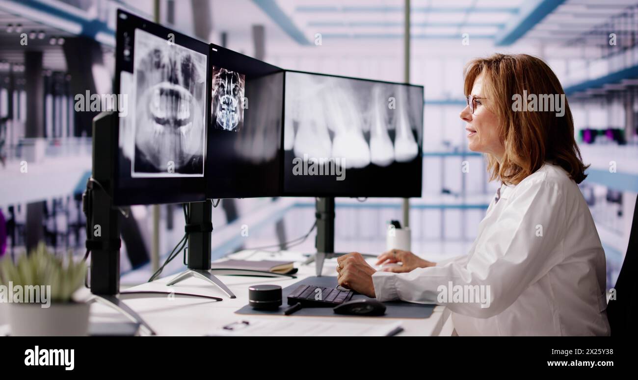 Dentist Doctor Looking At Teeth Xray On Computer Stock Photo