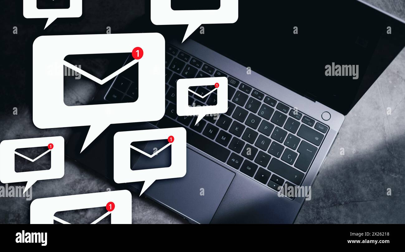 New email notification hologram over top view of laptop and copy space. Business e-mail communication and digital marketing. Electronic message alert. Stock Photo