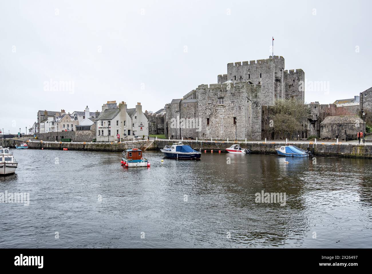 The walls of Rushen Castle overlooking the tidal harbour area in Castletown, Isle of Man Stock