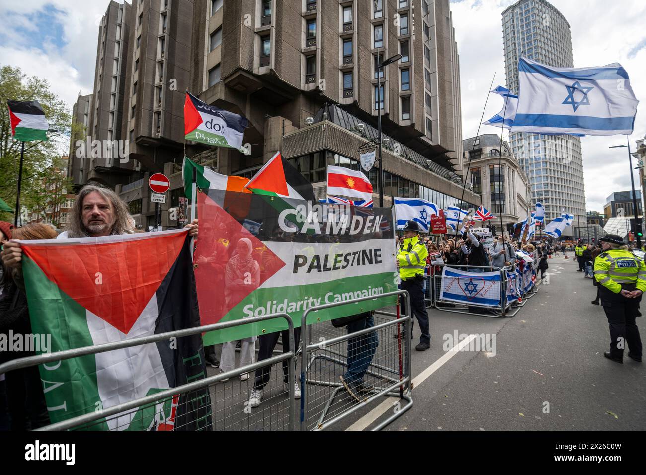 London, UK.  20 April 2024.  (R) Pro Israel supporters stage a counter-protest at the same time as Pro-Palestine supporters demonstrating outside Barclays bank on Tottenham Court Road as the Israel - Hamas war continues in Gaza.  The police watch on and keeps the two groups apart.  Credit: Stephen Chung / Alamy Live News Stock Photo