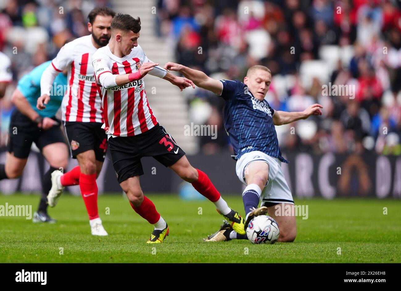 Sunderland's Chris Rigg (left) and Millwall's Casper de Norre battle for the ball during the Sky Bet Championship match at the Stadium of Light, Sunderland. Picture date: Saturday April 20, 2024. Stock Photo