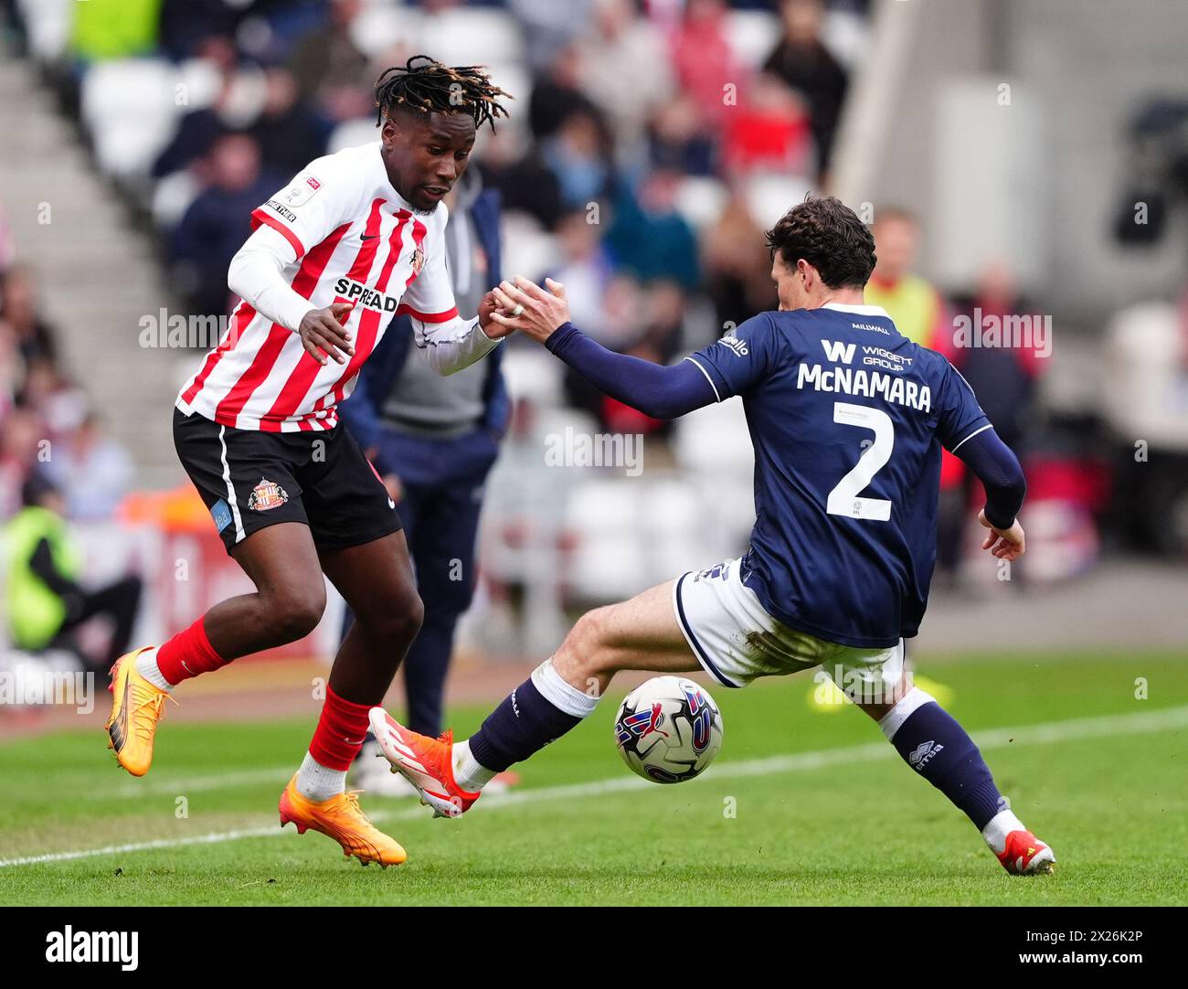 Sunderland's Timothee Pembele (left) and Millwall's Dan McNamara battle for the ball during the Sky Bet Championship match at the Stadium of Light, Sunderland. Picture date: Saturday April 20, 2024. Stock Photo