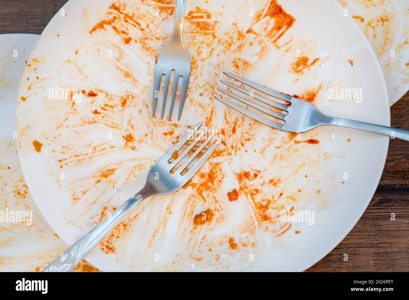 dirty plates after eating. Cutlery. forks on a plate. Dirty dishes after eating. End of meal. Good appetite, delicious food and dish concept Stock Photo