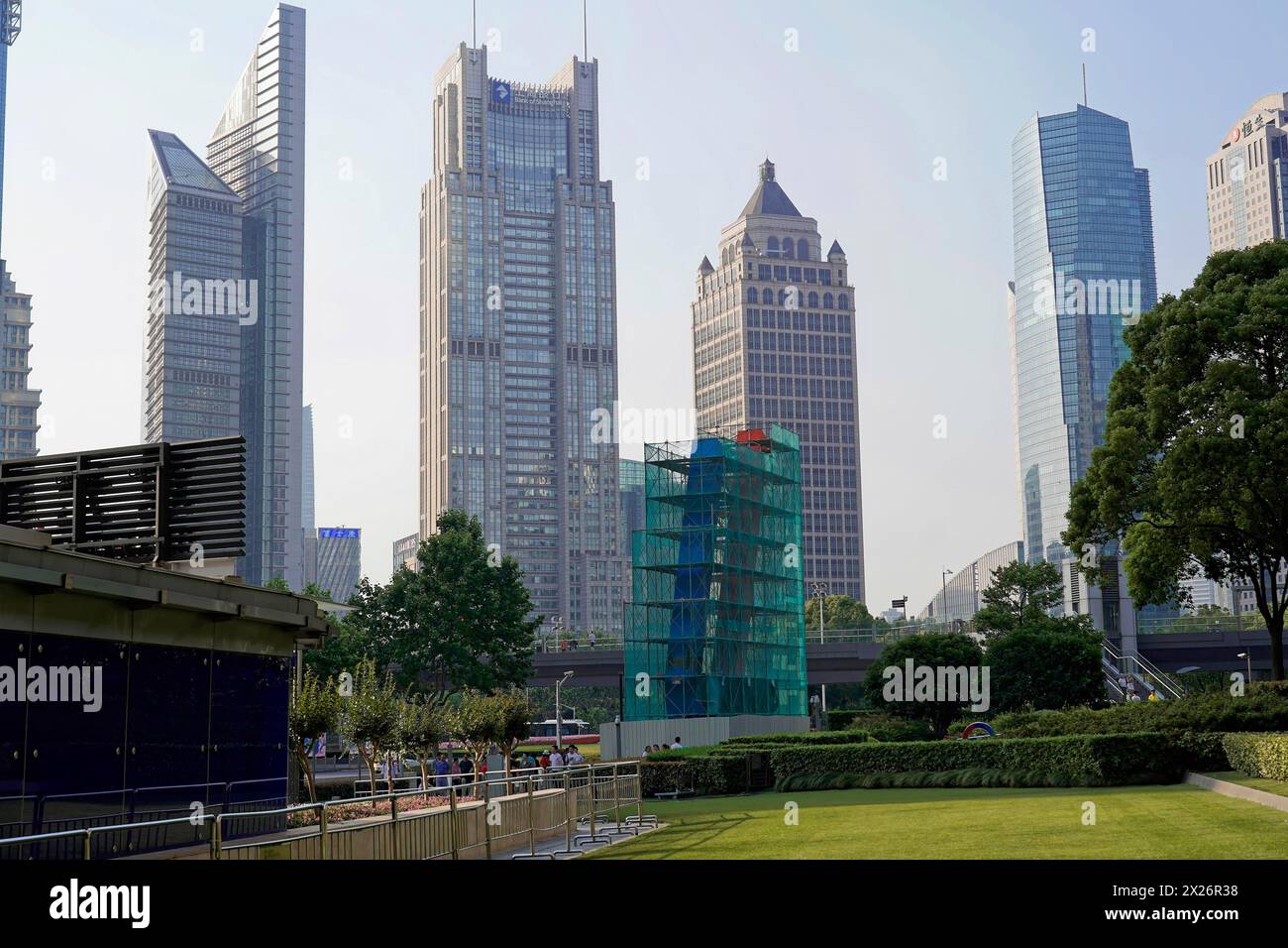 Skyscrapers of Pudong Special Economic Zone, Urban scene with skyscrapers next to green areas under a blue sky, Shanghai, China Stock Photo