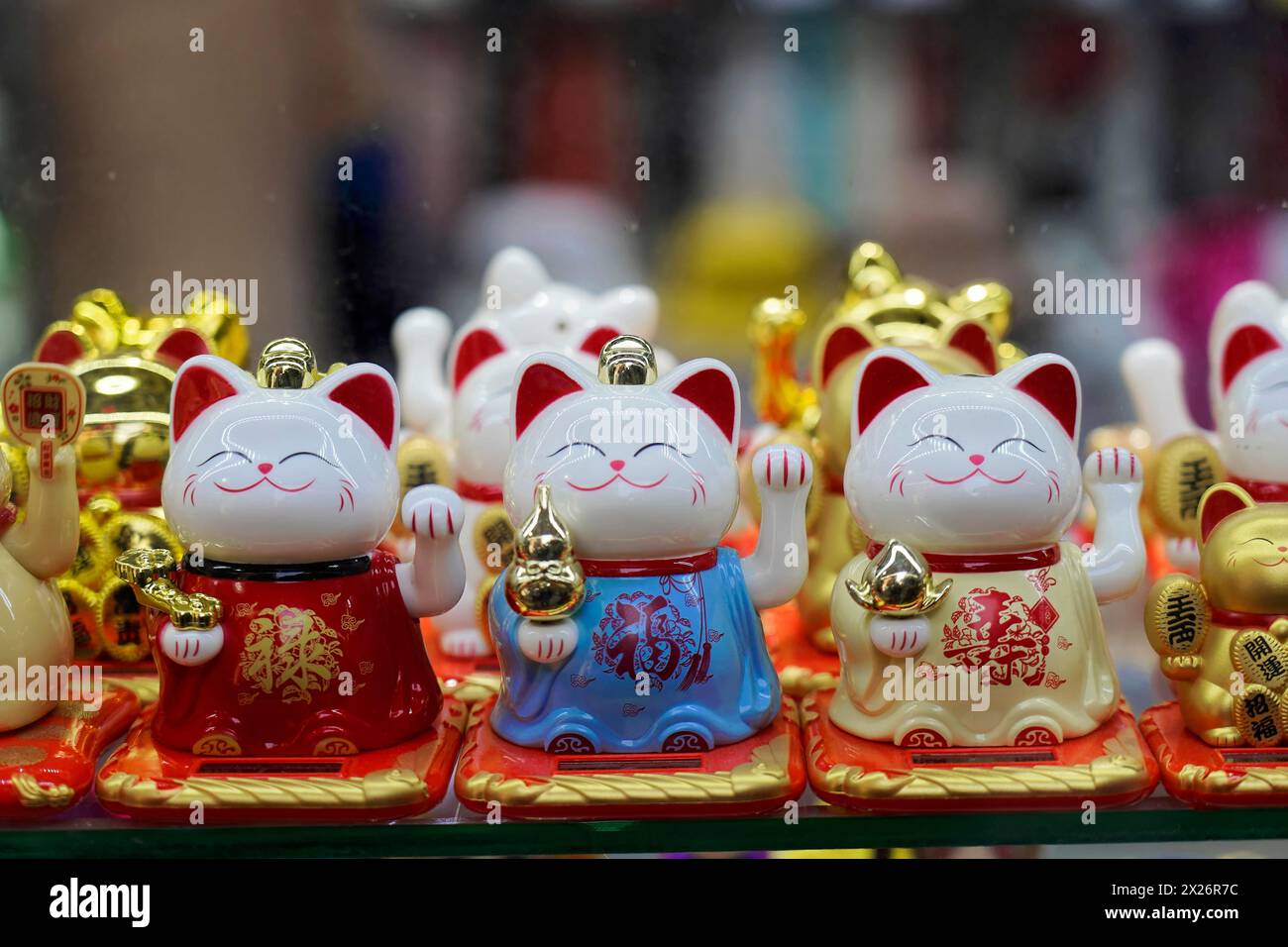 Strolling through the restored Tianzifang neighbourhood, A collection of golden waving cats, which are considered lucky charms, on a shelf, Shanghai Stock Photo