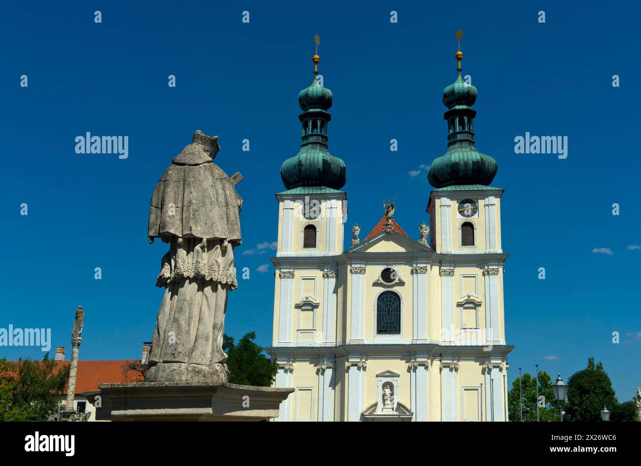Double-tower facade of the Basilica of the Nativity of the Virgin Mary with Marian column, Roman Catholic pilgrimage church in the town of Stock Photo