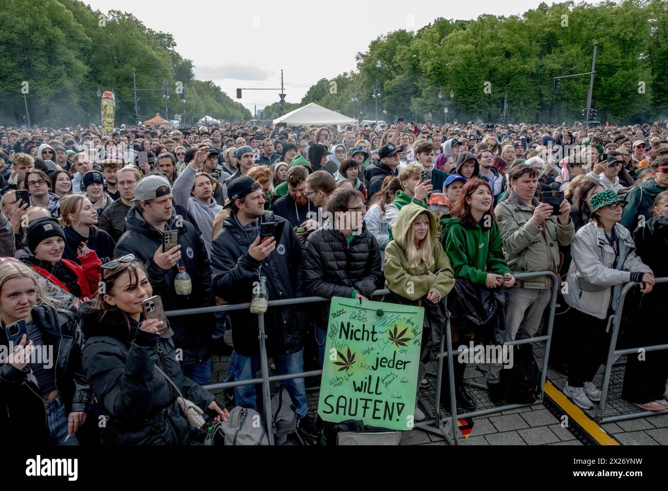 People gathered at the Brandenburg Gate in Berlin on Saturday, April 20, 2024, to celebrate the first legal 'Smoke-In' event, marking 420 Day, a date internationally recognized as a celebration of cannabis culture. Performances by notable acts such as Marsimoto, Green, Marvin Game, Ganjaman, and parts of Culcha Candela entertained the crowd, including prominent figures like Judge Andreas Müller of Bernau District Court. Müller, a well-known advocate for cannabis legalization, has been a visible proponent in the push for reform. Event organizers emphasized its significance as a demonstration of Stock Photo