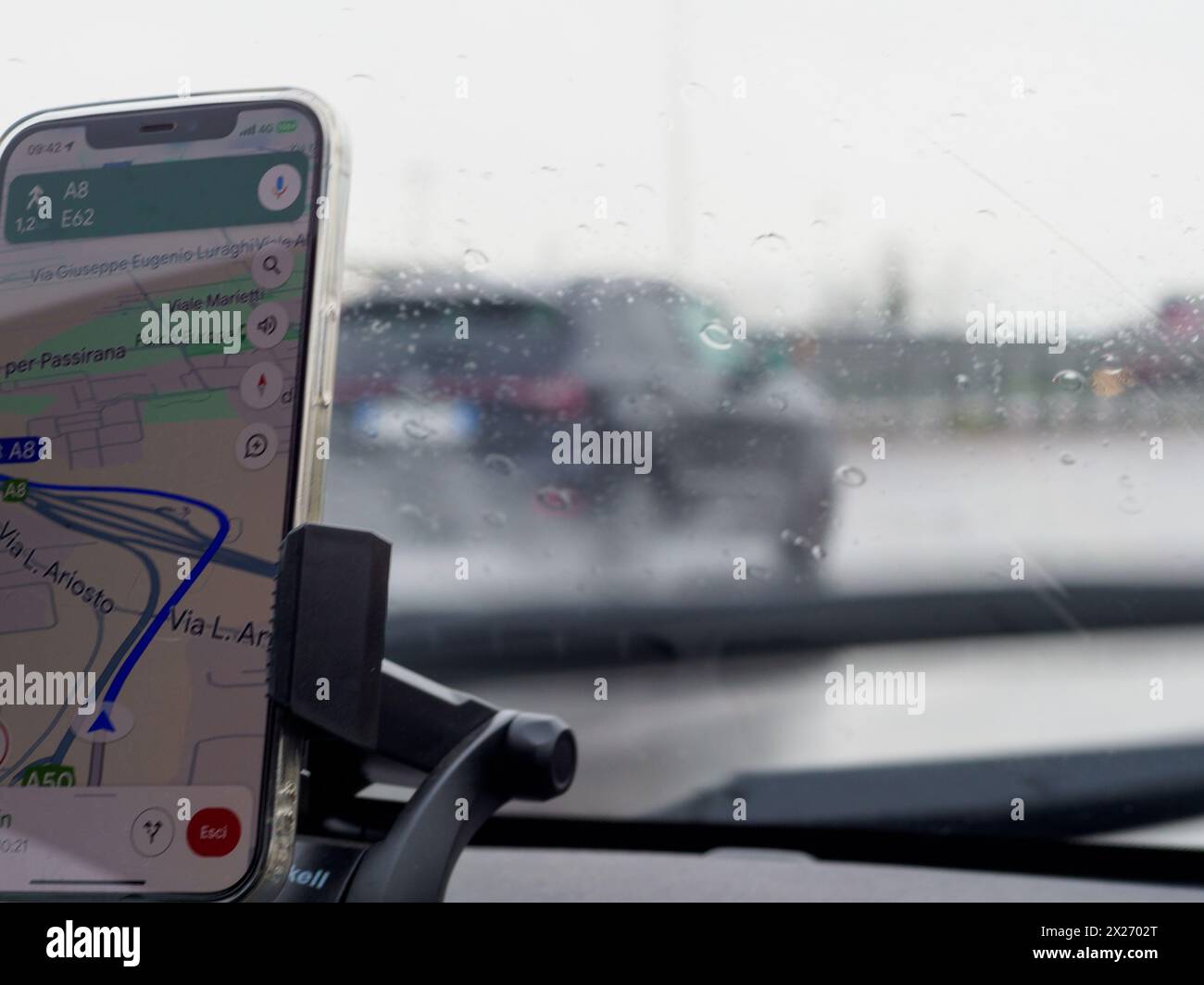Milan, Italy - April 26th 2023 View from inside a car with a smartphone navigation setup driving Stock Photo