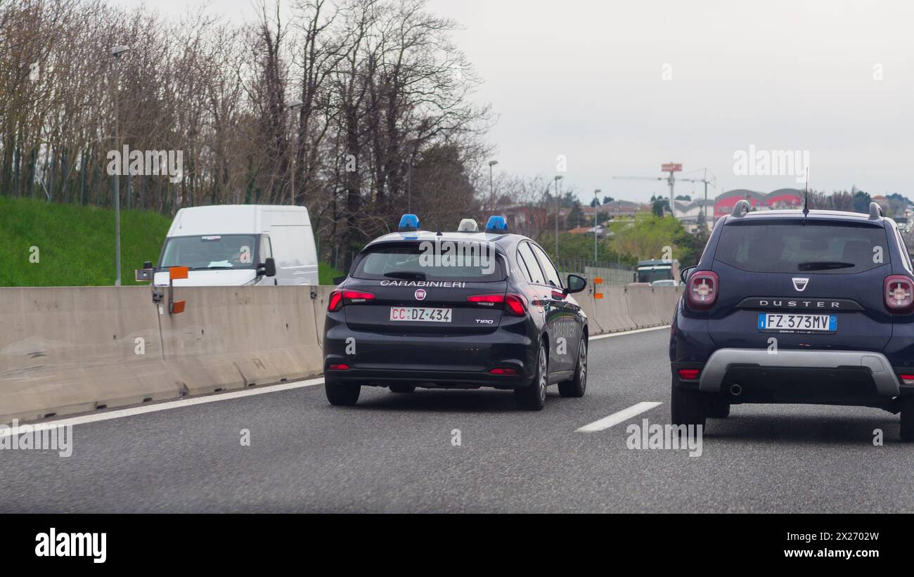 Milan, Italy - April 26th 2023 Carabinieri police Following a car on a highway under cloudy conditions, A1 A8 highway near Milan, Italy Stock Photo