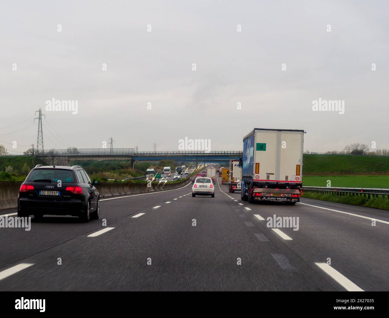 Milan, Italy - April 26th 2023 Following a car on a highway under cloudy conditions, A1 A8 highway near Milan, Italy Stock Photo