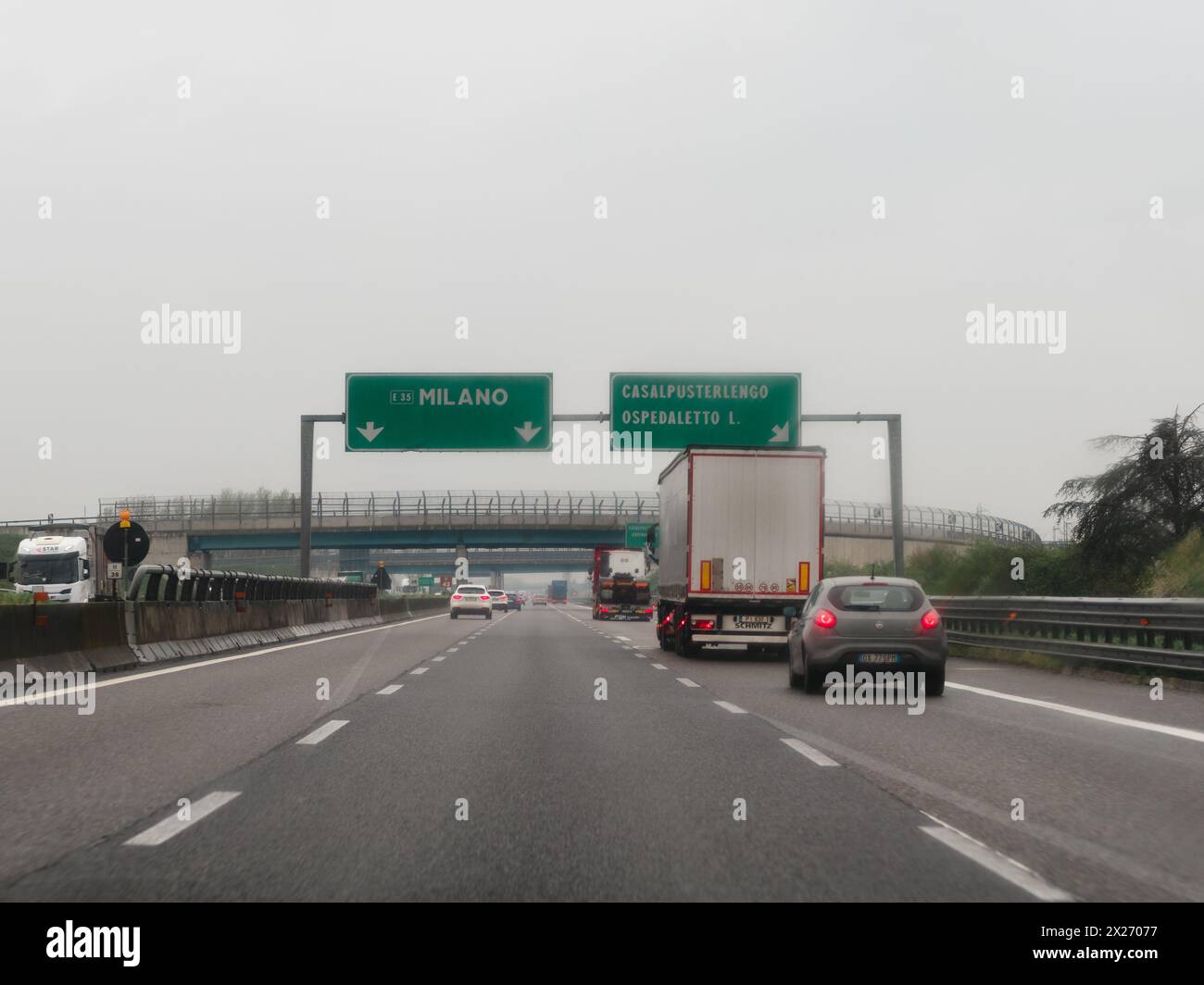 Milan, Italy - April 26th 2023 on the road on a highway under cloudy conditions, A1 A8 highway near Milan, Italy Stock Photo