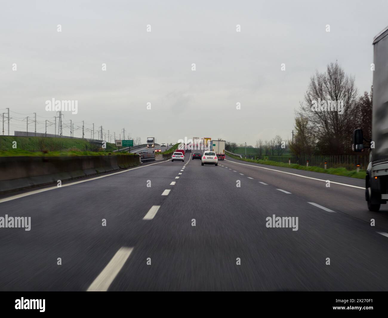 Milan, Italy - April 26th 2023 Following a car on a highway under cloudy conditions, A1 A8 highway near Milan, Italy Stock Photo