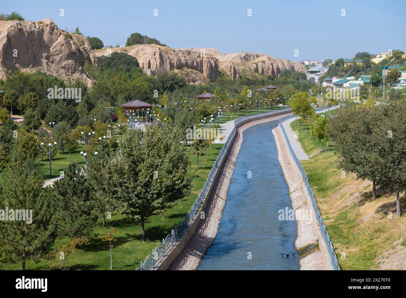 Urban landscaped park with a canal on the outskirts of Samarkand on a sunny day. Uzbekistan Stock Photo