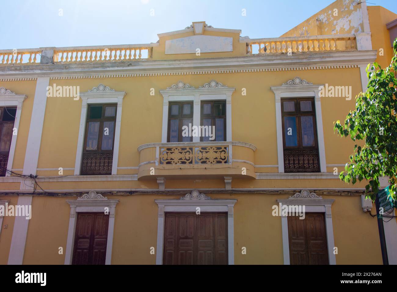 Old yellow house with a balcony in the Spanish town of Galdar on Gran Canaria Stock Photo
