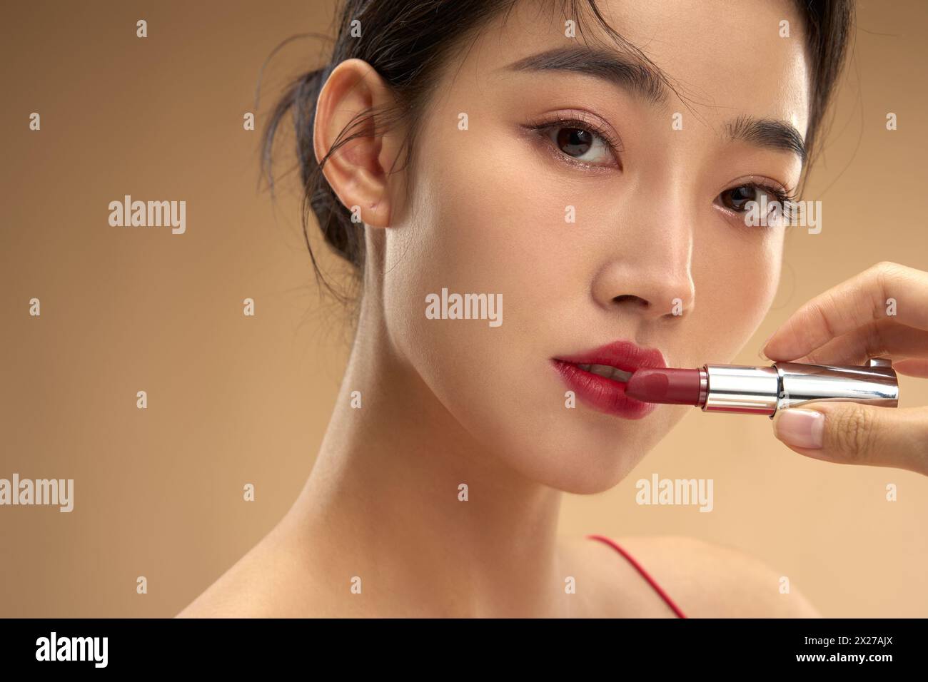 Young and beautiful women apply makeup and lipstick Stock Photo