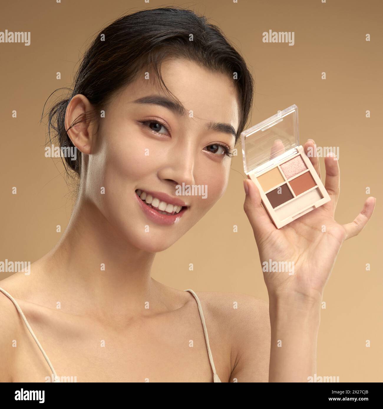 Young beauty with eye shadow box Stock Photo