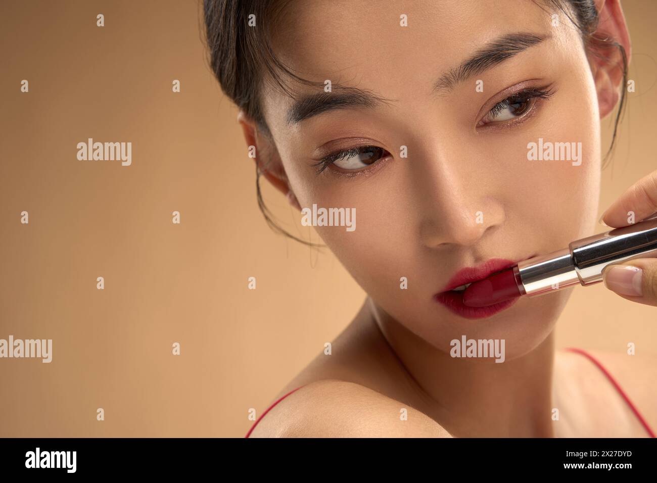 Young and beautiful women apply makeup and lipstick Stock Photo