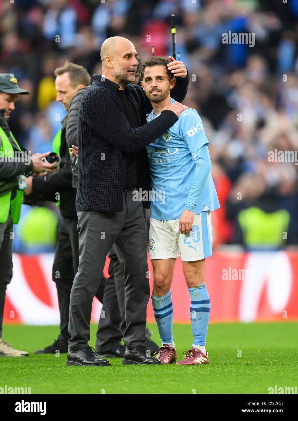 London, UK. 20th Apr, 2024 - Manchester City v Chelsea - FA Cup Semi-Final - Wembley.                                                                                      Pep Guardiola celebrates with goalscorer and match-winner Bernardo Silva at the final whistle.                                                                  Picture Credit: Mark Pain / Alamy Live News Stock Photo