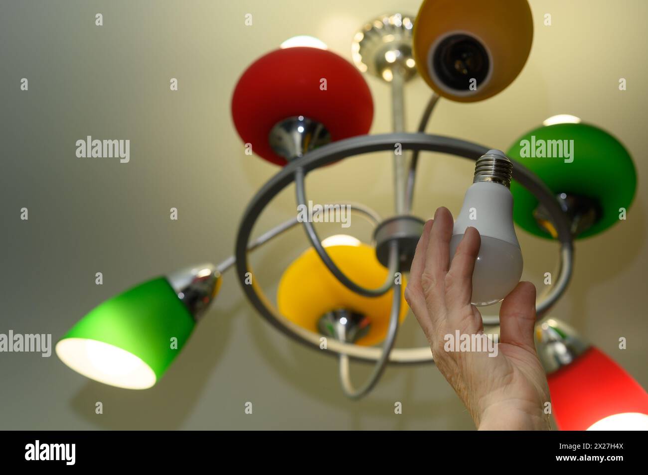 installation of an energy-efficient LED lamp Stock Photo