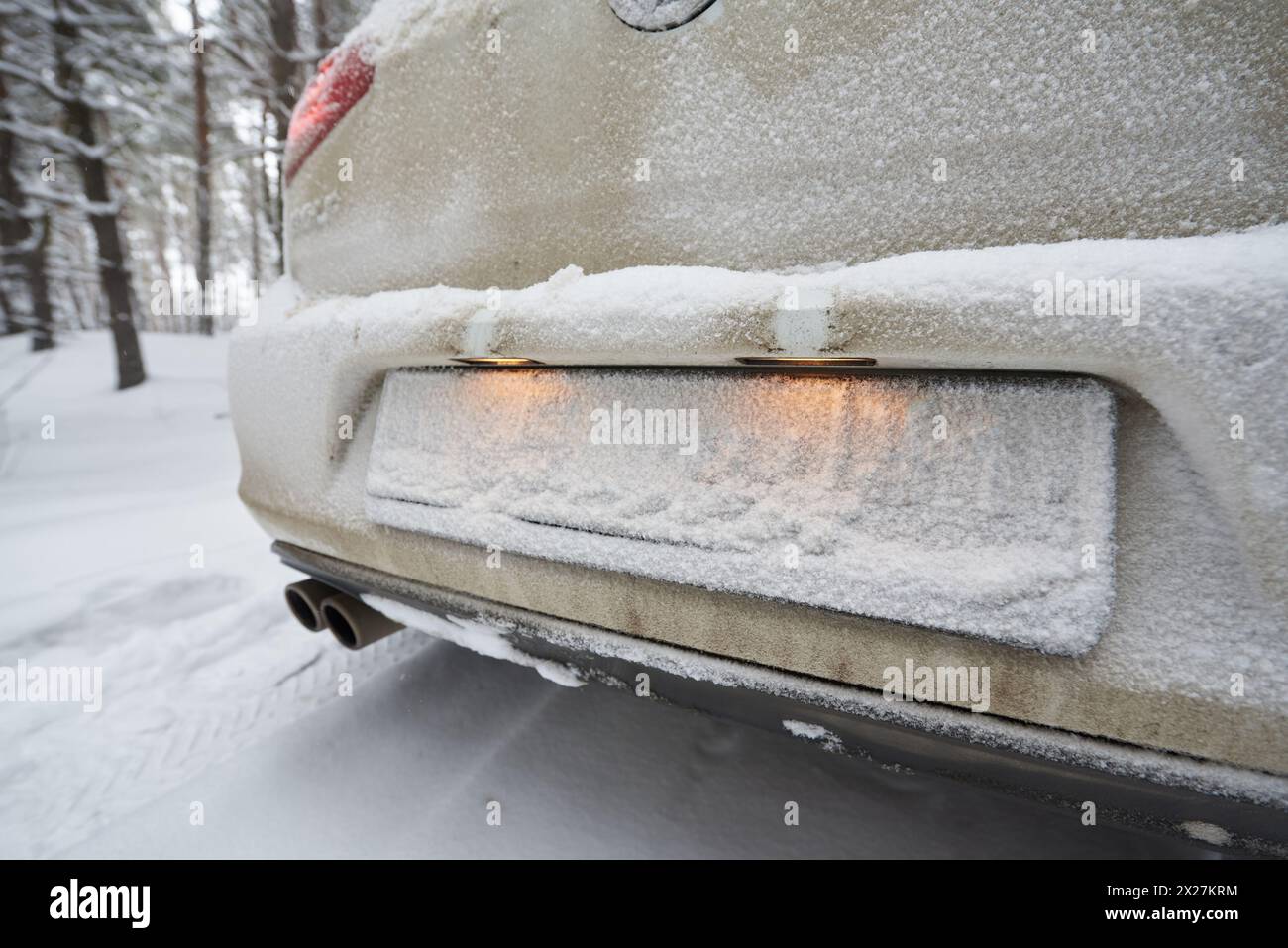 The license plate on the car is hidden by the snow. Stock Photo