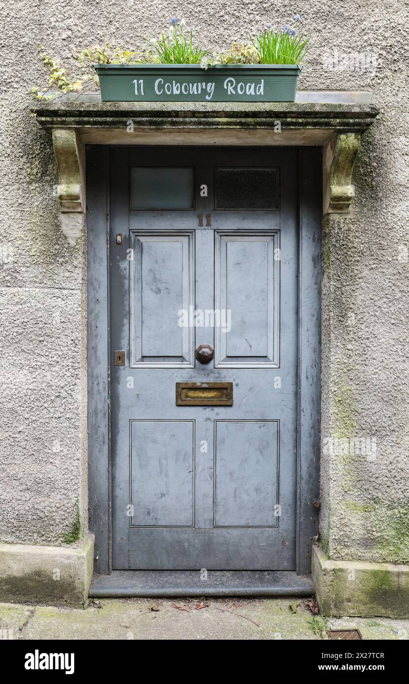 Bristol, England- March 29, 2024: Typical British house with gray door and potted plants in Bristol, England Stock Photo