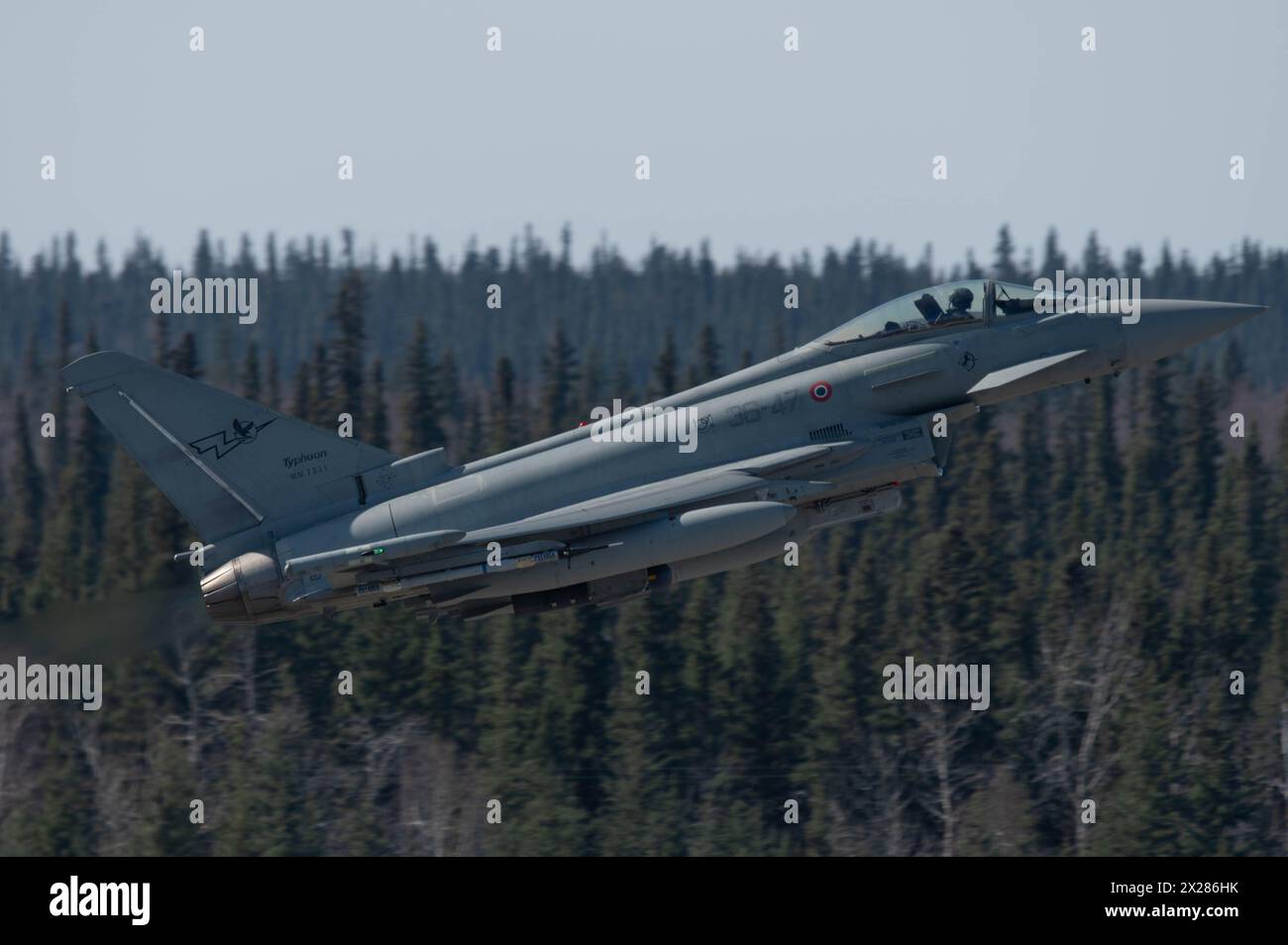 An Italian Air Force Eurofighter Typhoon takes flight during Red Flag-Alaska 24-1 at Eielson Air Force Base, Alaska, April 19, 2024. The Joint Pacific Alaska Range Complex airspace covers more than 77,000 square miles and provides realistic engagements, ranging from individual skills to complex, large-scale joint engagements. (U.S Air Force photo by Airman 1st Class Carson Jeney) Stock Photo