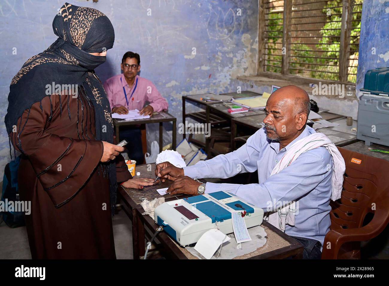 Saharanpur, India. 19th Apr, 2024. A Muslim woman wearing a chadri, has her finger marked with indelible ink before voting in the first phase of General Elections at a polling station, April 19, 2024 in Saharanpur, Uttar Pradesh, India. Nearly 969 million people are eligible to vote in the world's biggest democracy with polling taking place in seven phases over the next six weeks. Credit: Brij Mohan Meena/Press Information Bureau/Alamy Live News Stock Photo