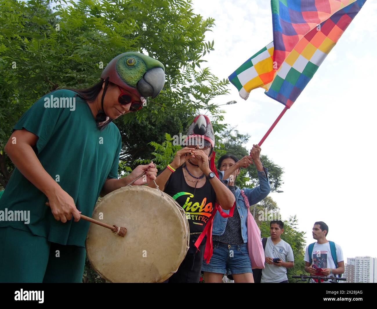 Lima, Peru. 20th Apr, 2024. Activists playing drums and waving a Wiphala, the indigenous flag of the Andes when dozens of demonstrators and environmentalists took to the streets, demonstrating for the recent modifications to the forestry law that would facilitate the deforestation of the Amazon and illegal logging Credit: Fotoholica Press Agency/Alamy Live News Stock Photo