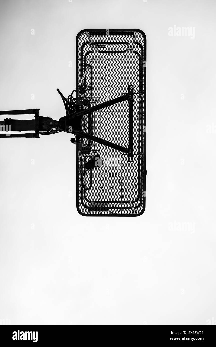 directly underneath a caged aerial work platform lift. Stock Photo