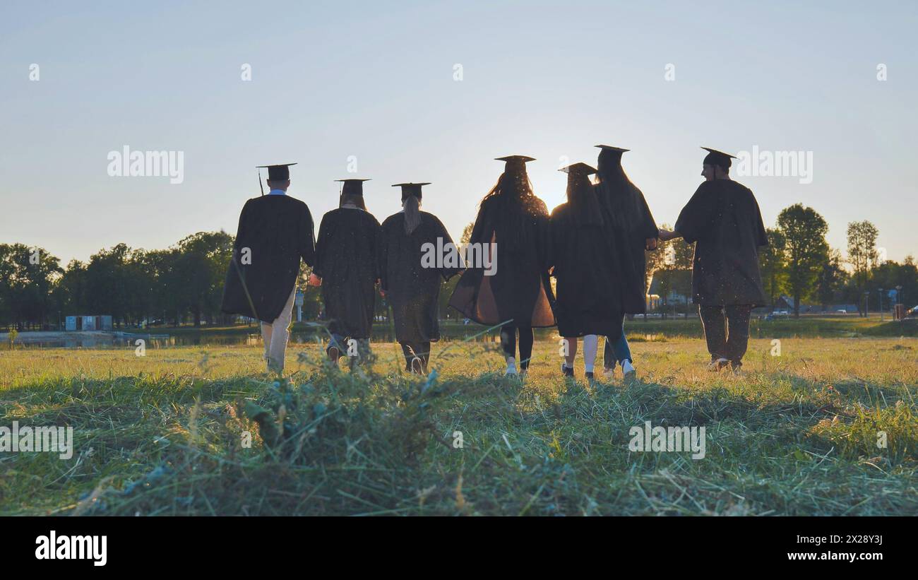 College graduates walk sunset hi-res stock photography and images - Alamy