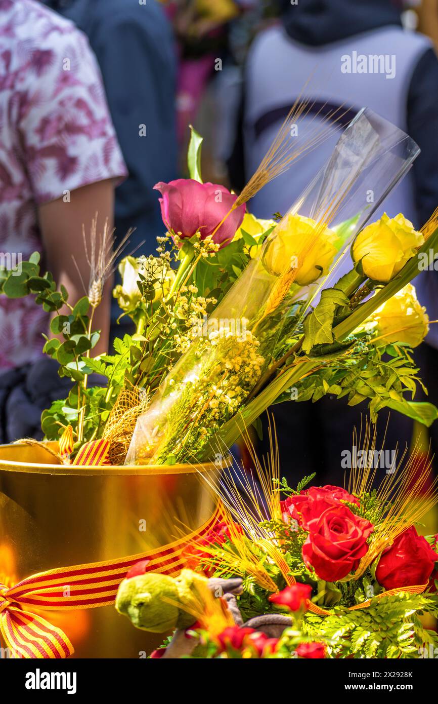 Yellow and red roses in a golden pot with a bow of the flag of ...