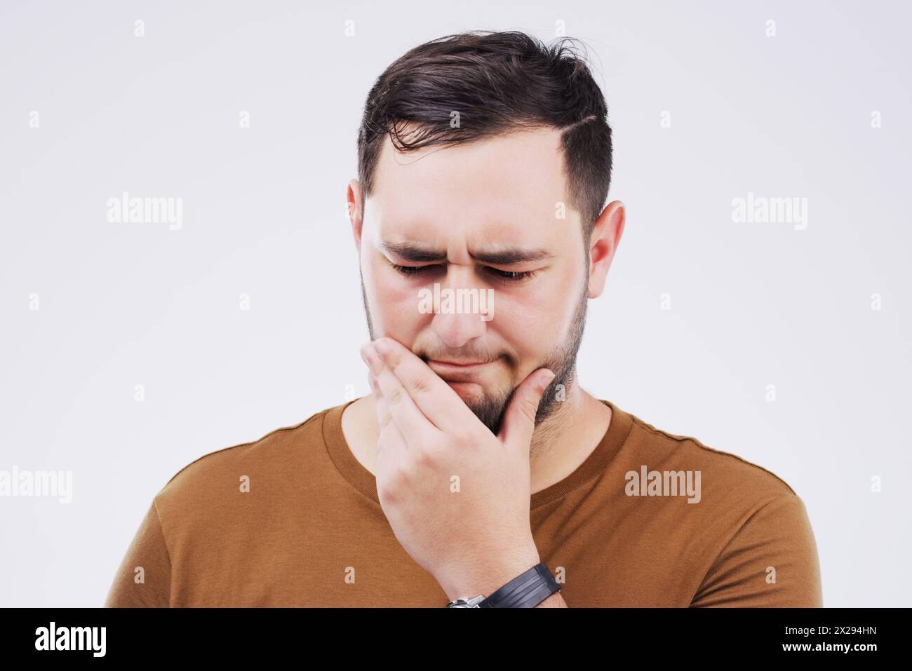 Man, confused and thinking in studio white background for doubt, choice or remember. Male person, idea or memory with thoughts for question, difficult Stock Photo