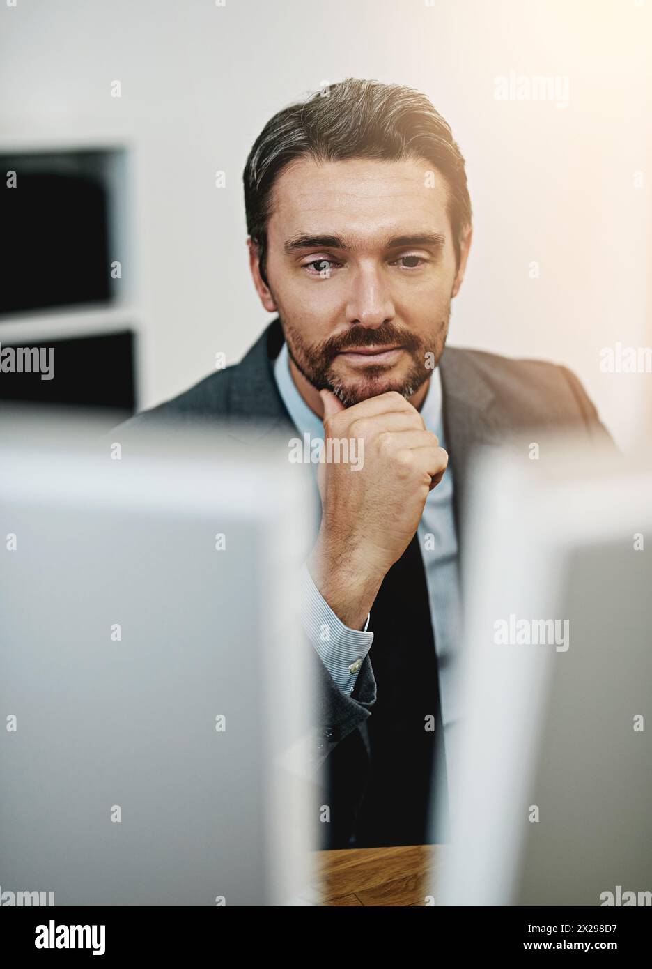 Business man, computer and thinking in office for information technology, software or online programming. Programmer or web developer reading on his Stock Photo