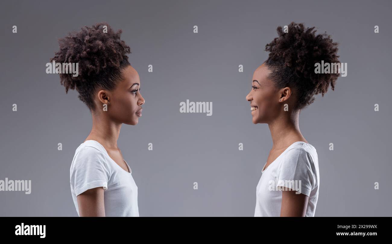 Judgement and joy clash in a visual self-dialogue between two expressions of the same black woman Stock Photo