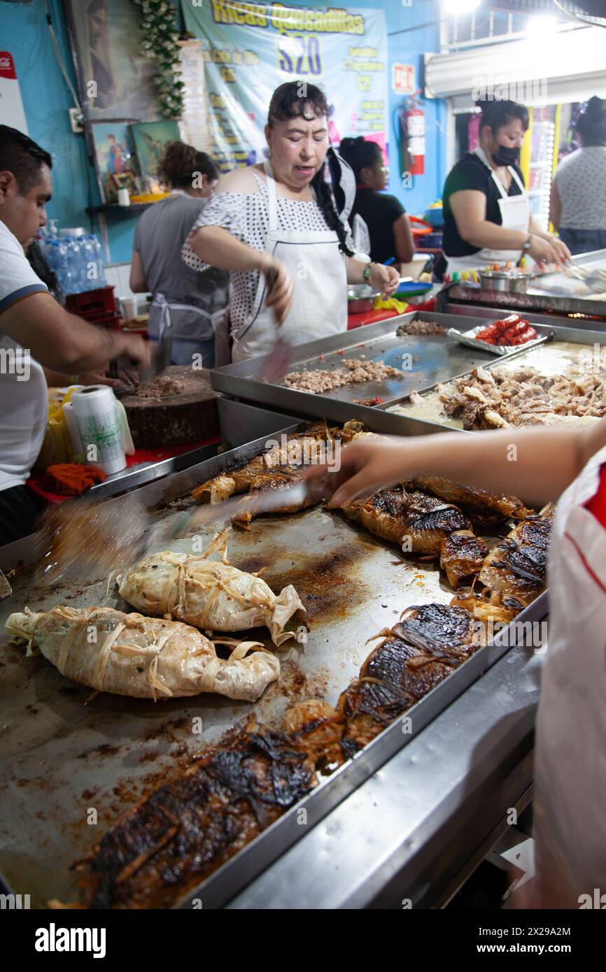 Food Vendor Selling Wrapped Fish on the Grill at Jamaica Market in Mexico City, Mexico Stock Photo