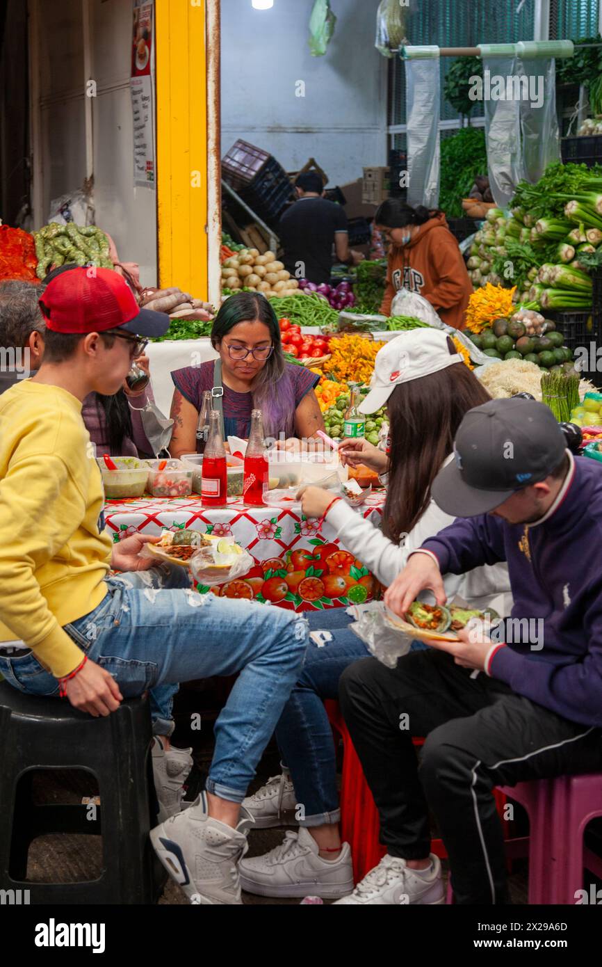 Teens Having lunch at Eatery Inside Jamaica Market in Mexico City, Mexico Stock Photo