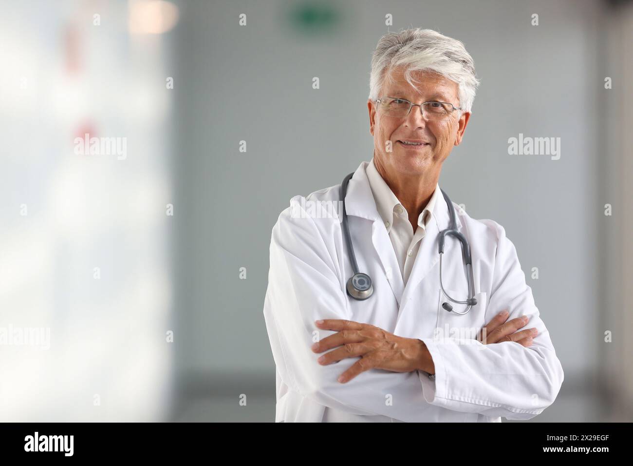 Adult doctor gray hair smiles hi-res stock photography and images - Alamy
