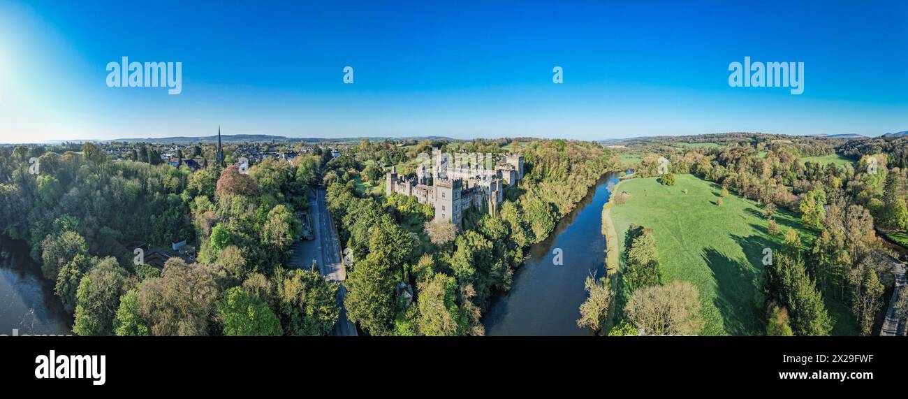 An aerial panorama reveals the majestic Lismore Castle in County Waterford, Ireland, set against a flawless spring sky Stock Photo