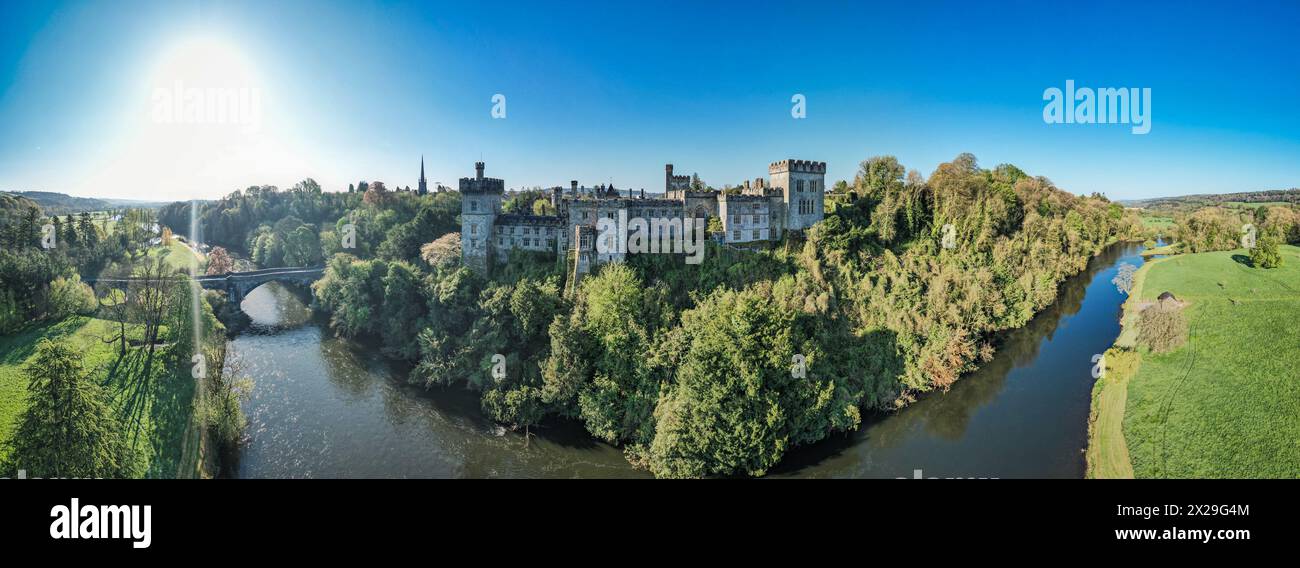 An aerial panorama reveals the majestic Lismore Castle in County Waterford, Ireland, set against a flawless spring sky Stock Photo