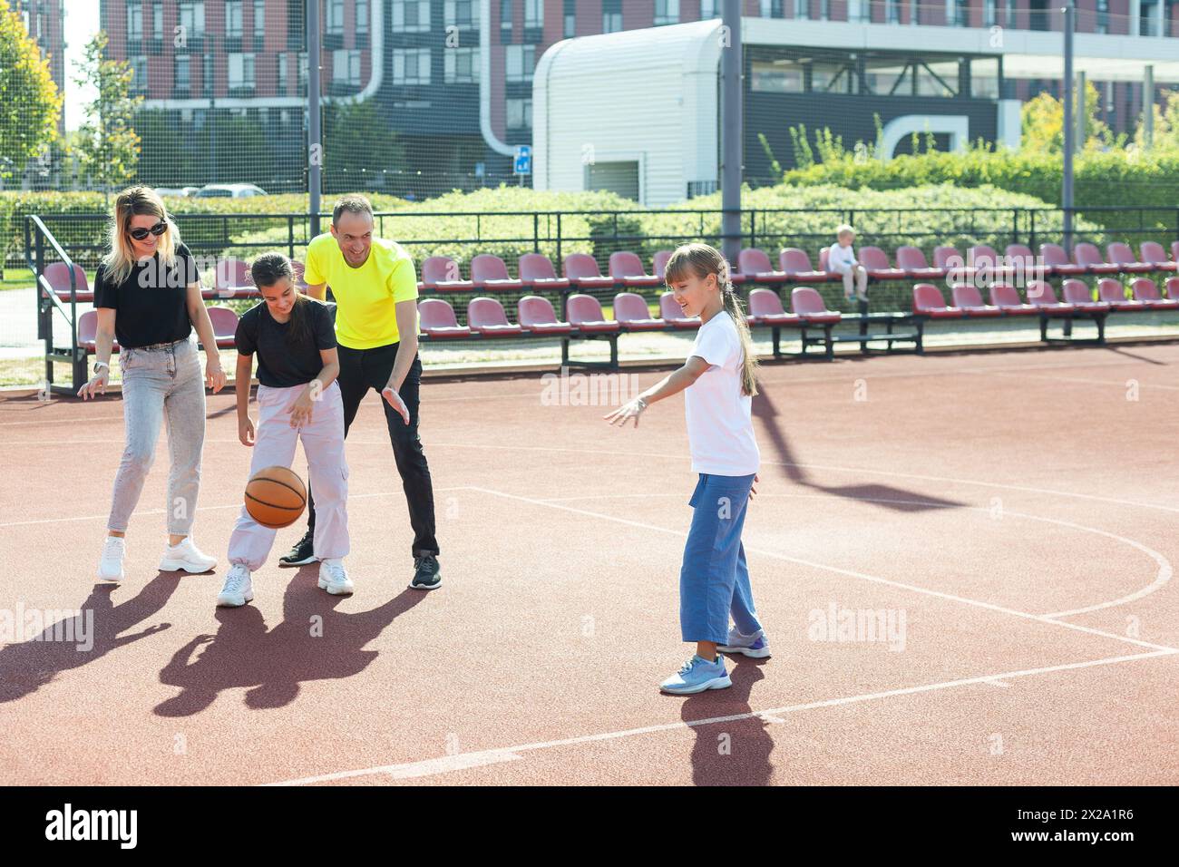 family playing basketball on court Stock Photo - Alamy