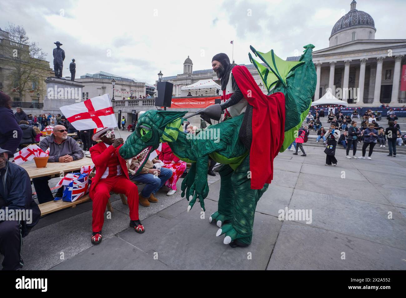 London 21 April 2024 .A man dressed as Saint George riding an inflatable dragon entertains the crowds  in  Trafalgar Square during the Saint George's celebrations. Credit: amer ghazzal/Alamy Live News Stock Photo