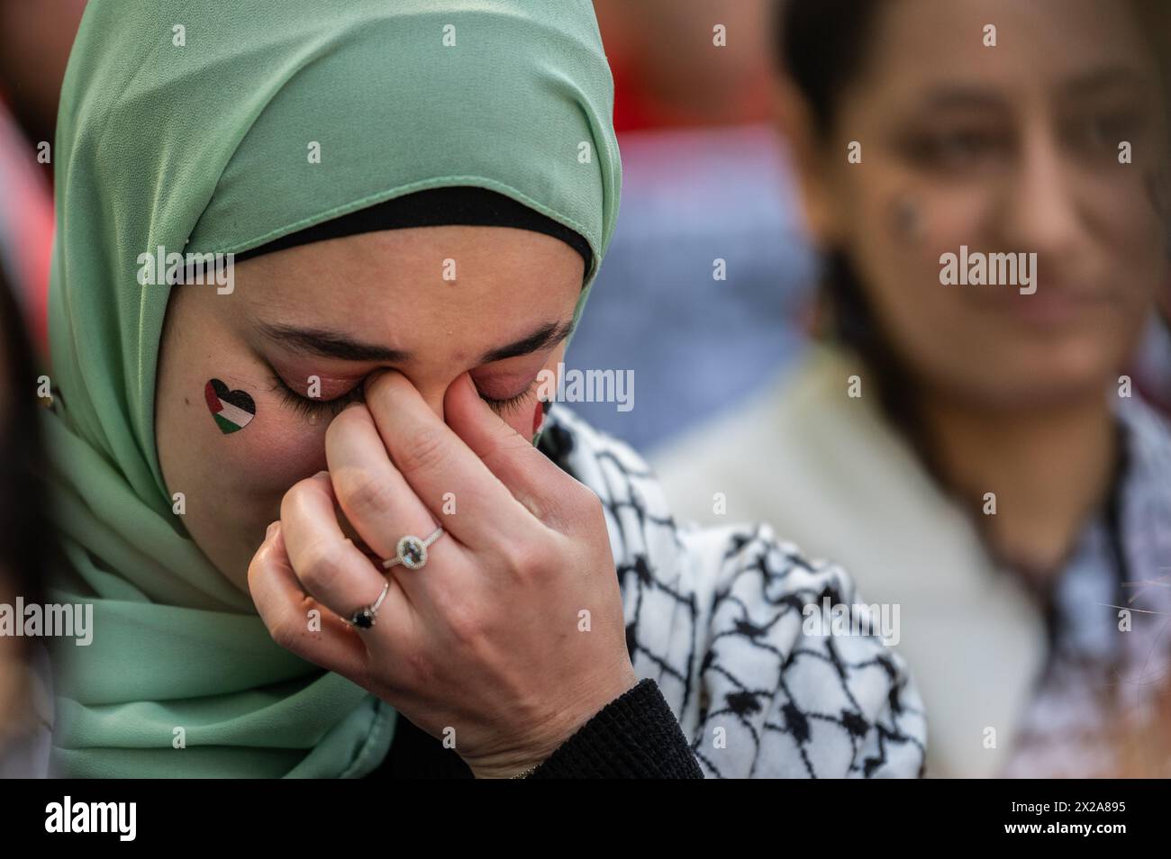 Madrid, Spain. 21st Apr, 2024. A woman is seen crying during a demonstration in support of the Palestinian people. Thousands of people rally in Madrid under the slogan 'stop genocide in Palestine' demanding the end of arms trade with Israel and a definitive ceasefire in the Gaza Strip. Credit: Marcos del Mazo/Alamy Live News Stock Photo