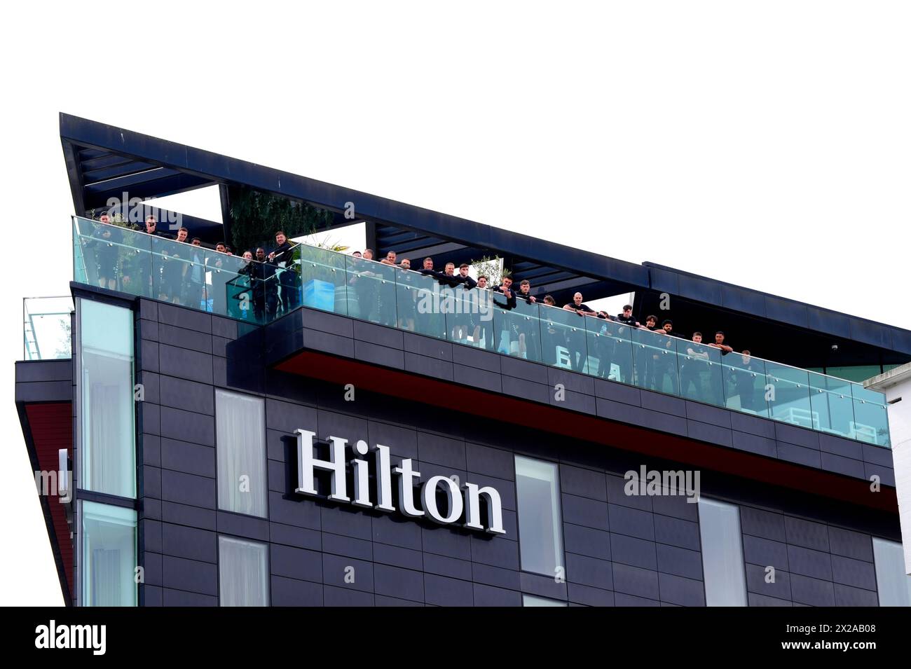 Coventry City players watch the fans arrive from the balcony of the Hilton hotel ahead of the Emirates FA Cup semi-final match at Wembley Stadium, London. Picture date: Sunday April 21, 2024. Stock Photo