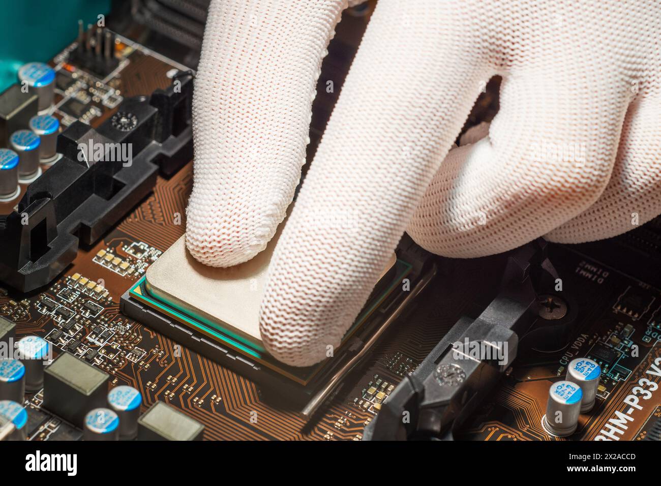 Man hand in white antistatic gloves installing computer processor Stock Photo