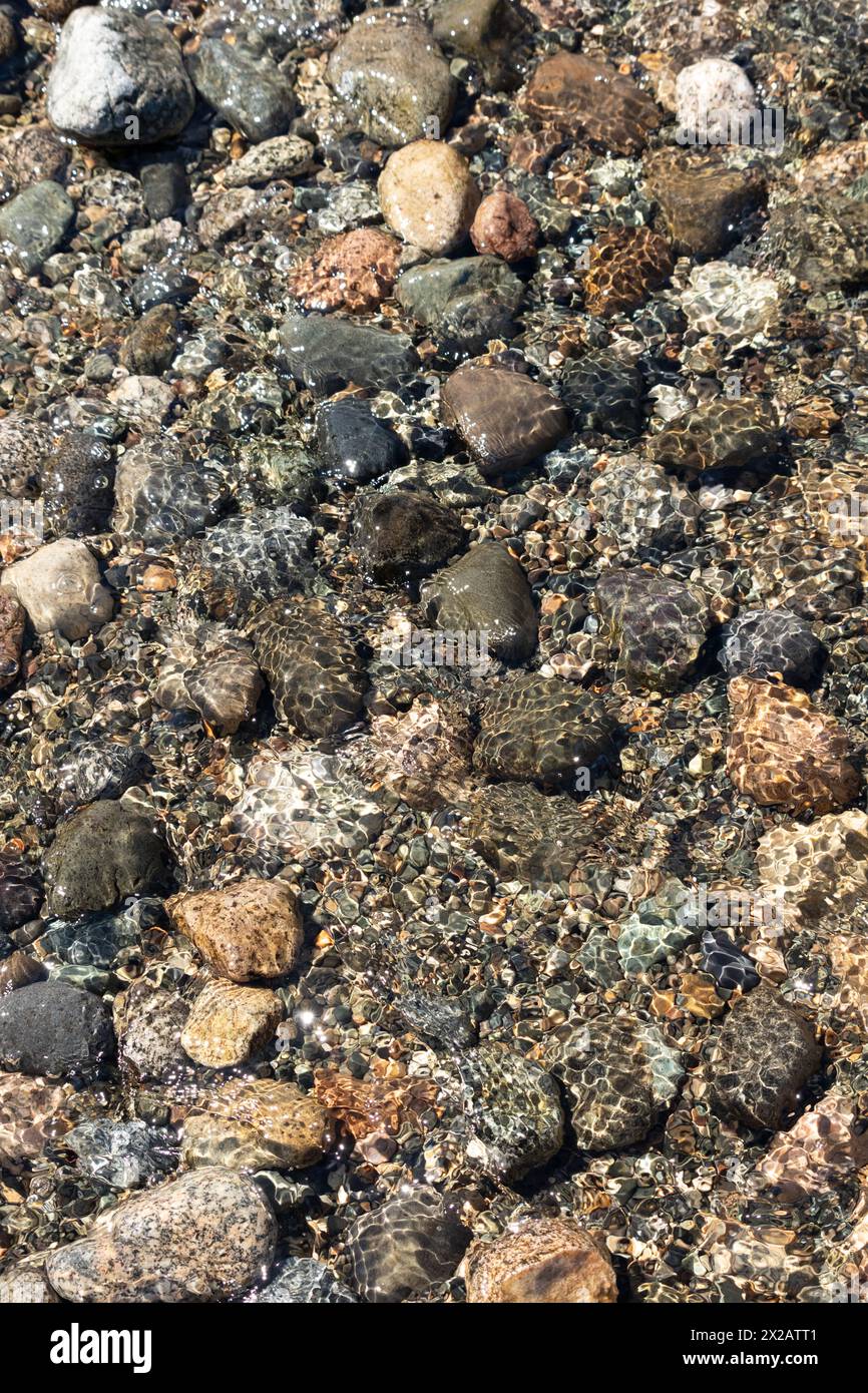 Many rocks and pebbles covered with sand in a dirt ground Stock Photo ...