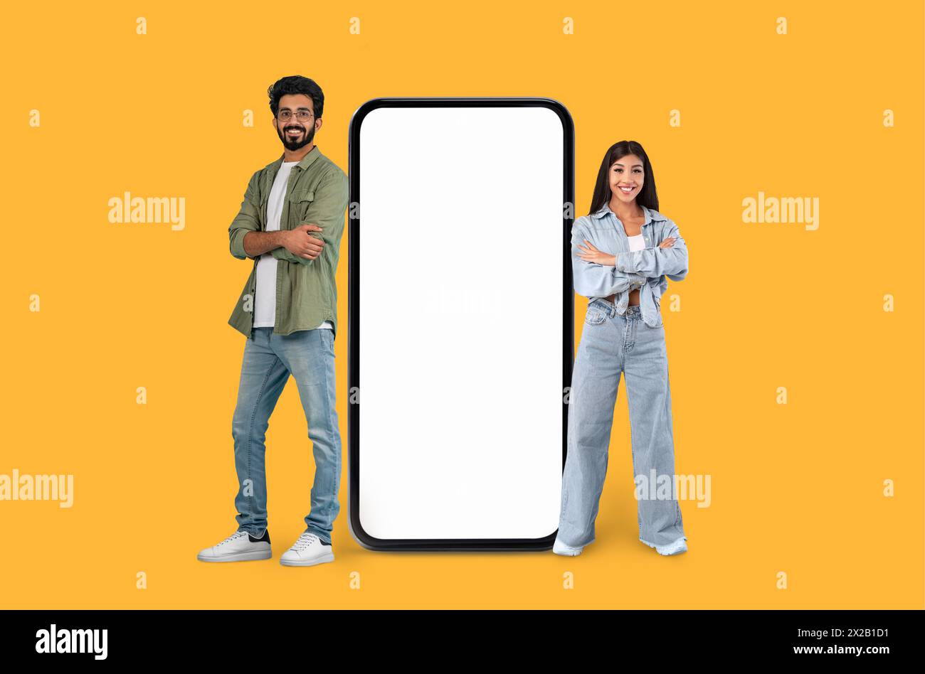 Two people next to a large smartphone mock Stock Photo