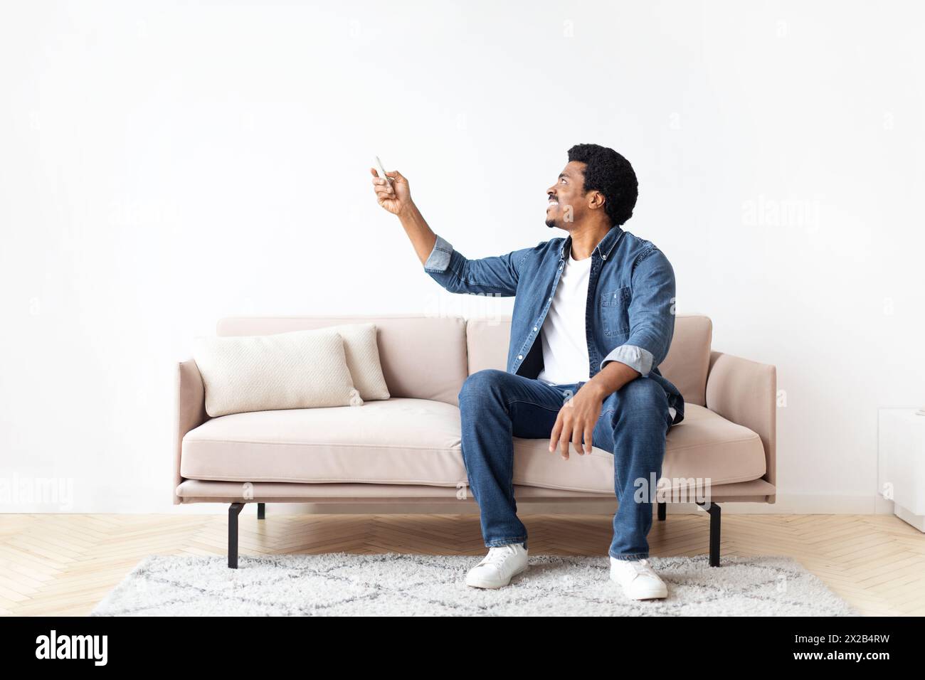 Engaged Black Guy Pointing at Something in his Home Stock Photo