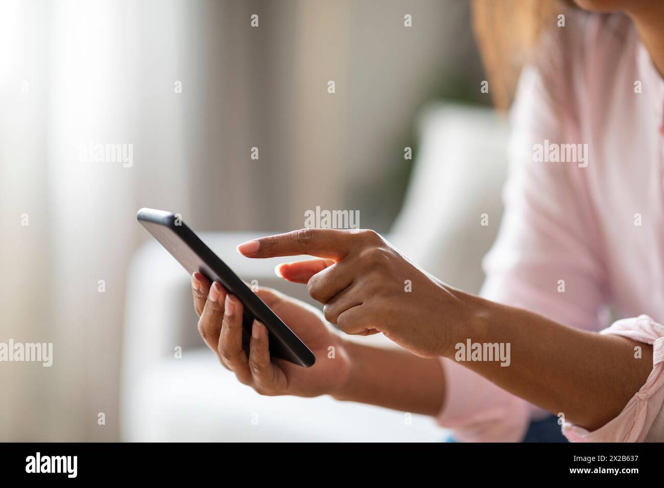 Focused black lady using a digital tablet Stock Photo